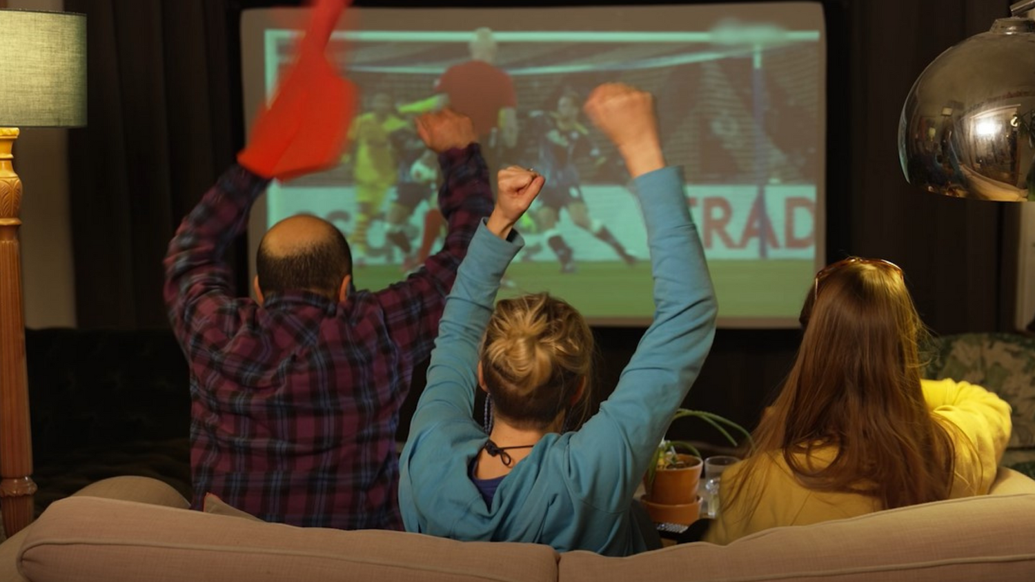 Image of friends watching a sports game on a pop up cinema screen