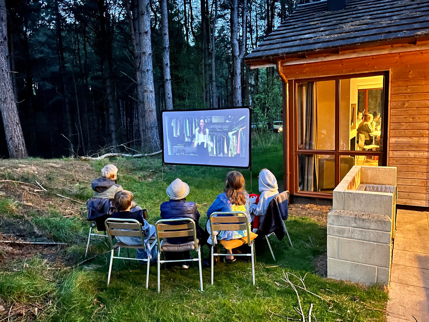 Image of family watching a film using a pop up cinema